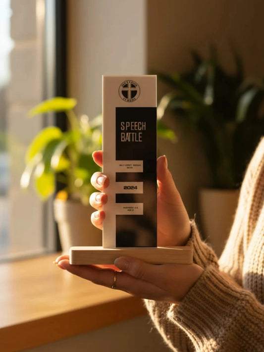 Hand holding a product box labeled 'Speech Battle' with plants and a window in the background
