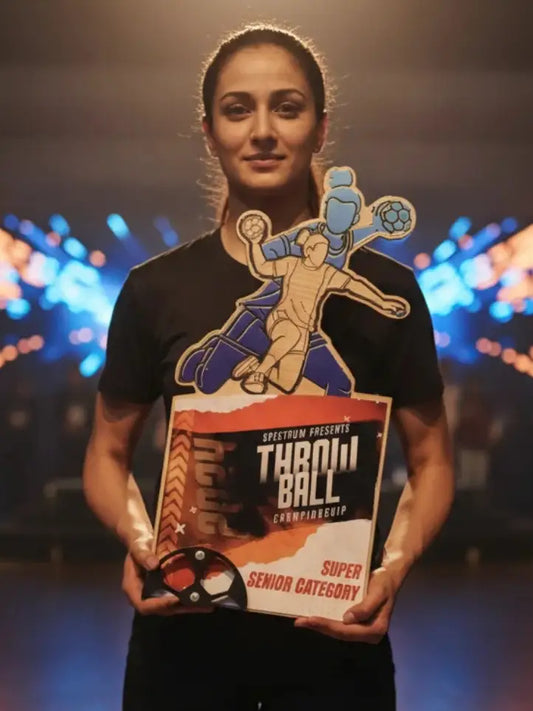 Person wearing a black t-shirt with a graphic design and text, holding a similar design, against a blurred colorful background.