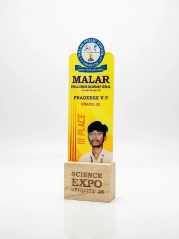 Yellow award plaque with a person's face on a white background