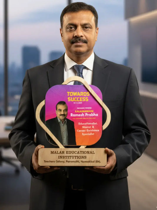 Man in a suit holding a plaque with 'Towards Success' and 'Malar Educational Institutions' on it.