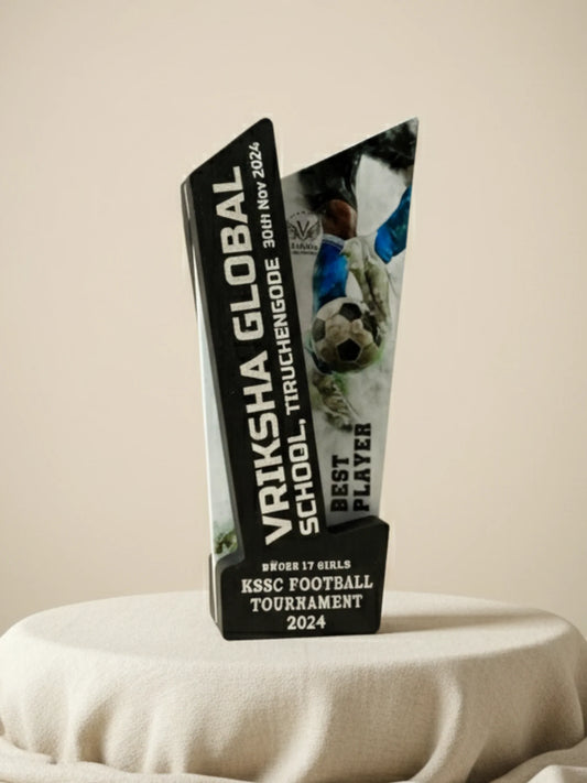 Trophy with engraved text on a beige surface