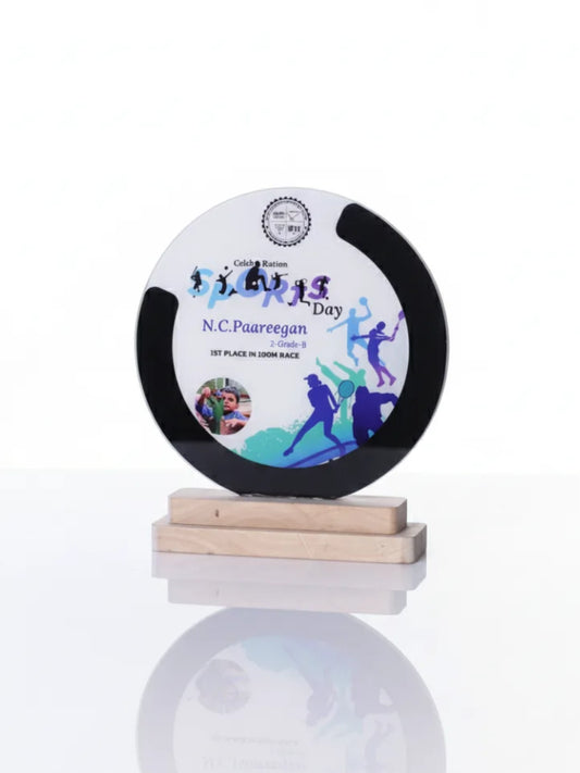 Circular trophy with a wooden base on a white background