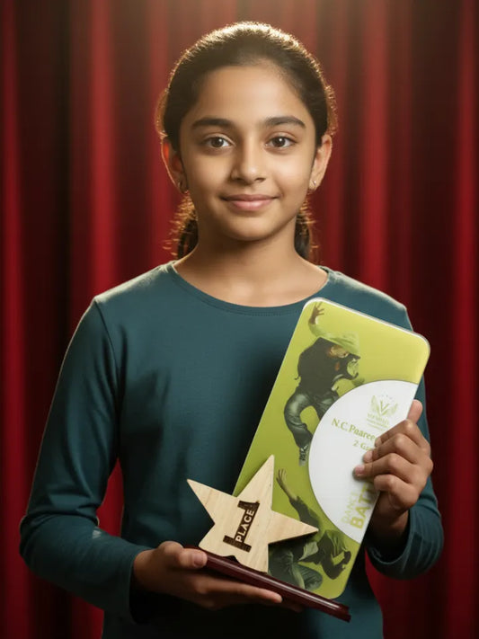 Young girl holding a book and a wooden award against a red curtain background
