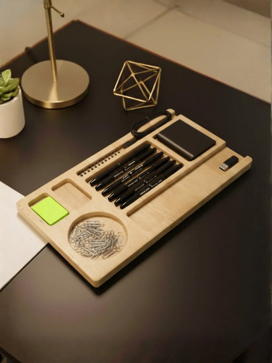 Wooden desk organizer with stationery items on a dark surface