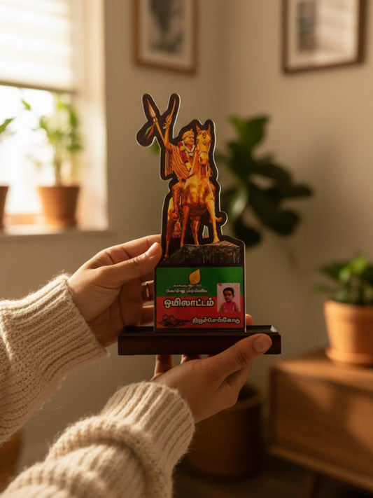 Person holding a decorative item with a horse and rider design in a home setting