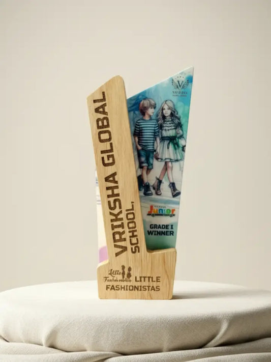 Trophy with 'Vriksha Global School' and 'Little Fashionistas' branding on a neutral background