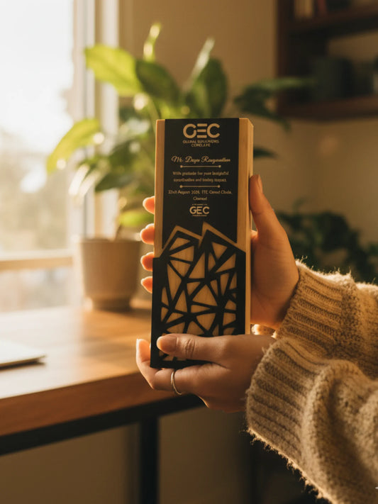 Hand holding a GEC product box with plants and a window in the background