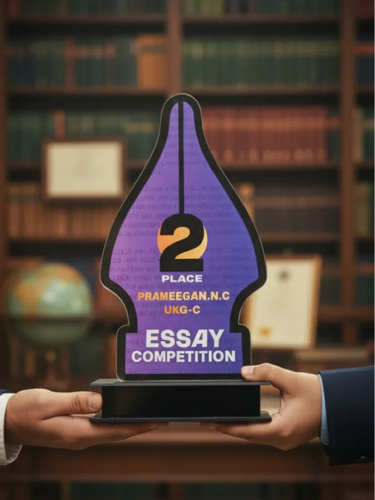 Two hands holding a trophy with '2nd Place' and 'Essay Competition' text against a bookshelf background.