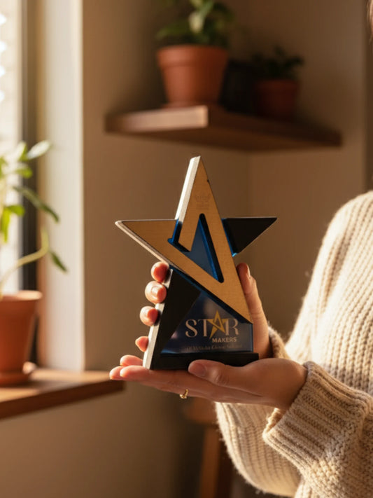 Person holding a star-shaped award in a home setting with plants in the background