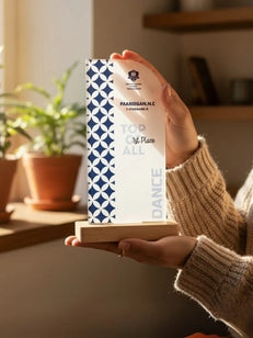 Person holding a decorative box with geometric pattern in a home setting