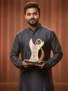 Man holding an award against a red curtain background