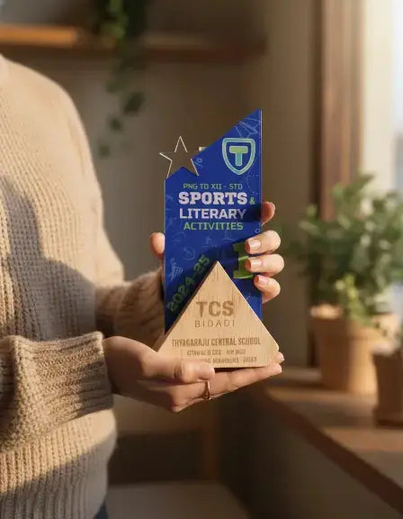 Person holding a blue and wooden award with 'TCS' branding indoors.