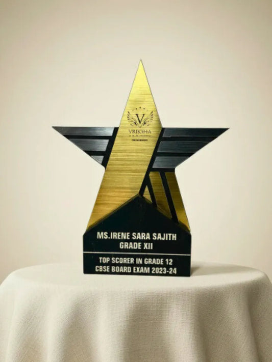 Star-shaped award with engraved text on a beige background