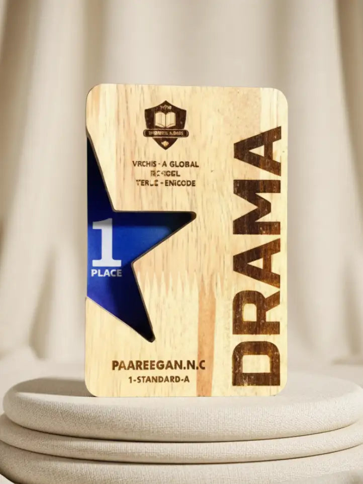 Wooden plaque with 'Drama' and '1 Place' text on a neutral background