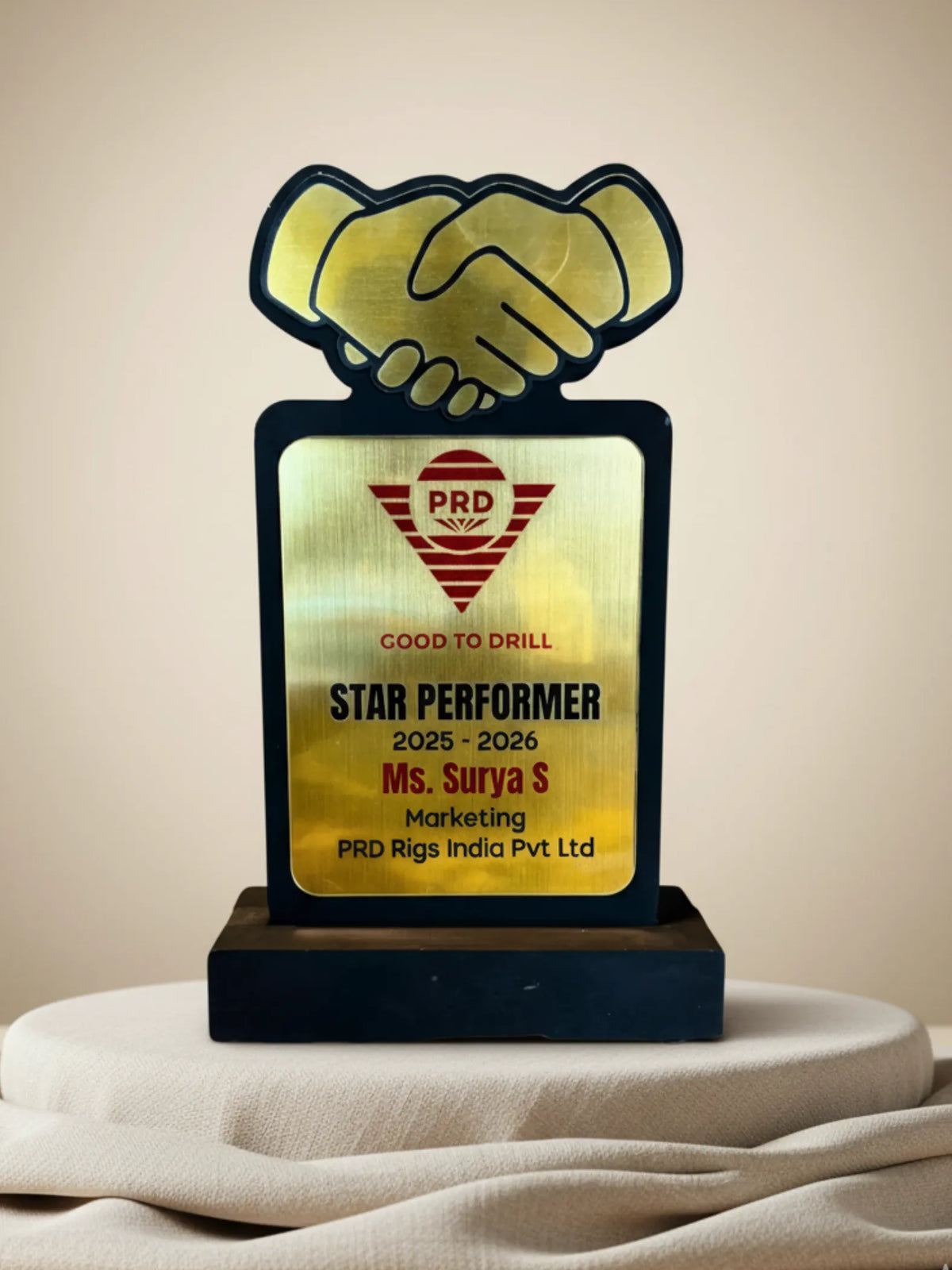 Awards trophy with a handshake design on a beige background
