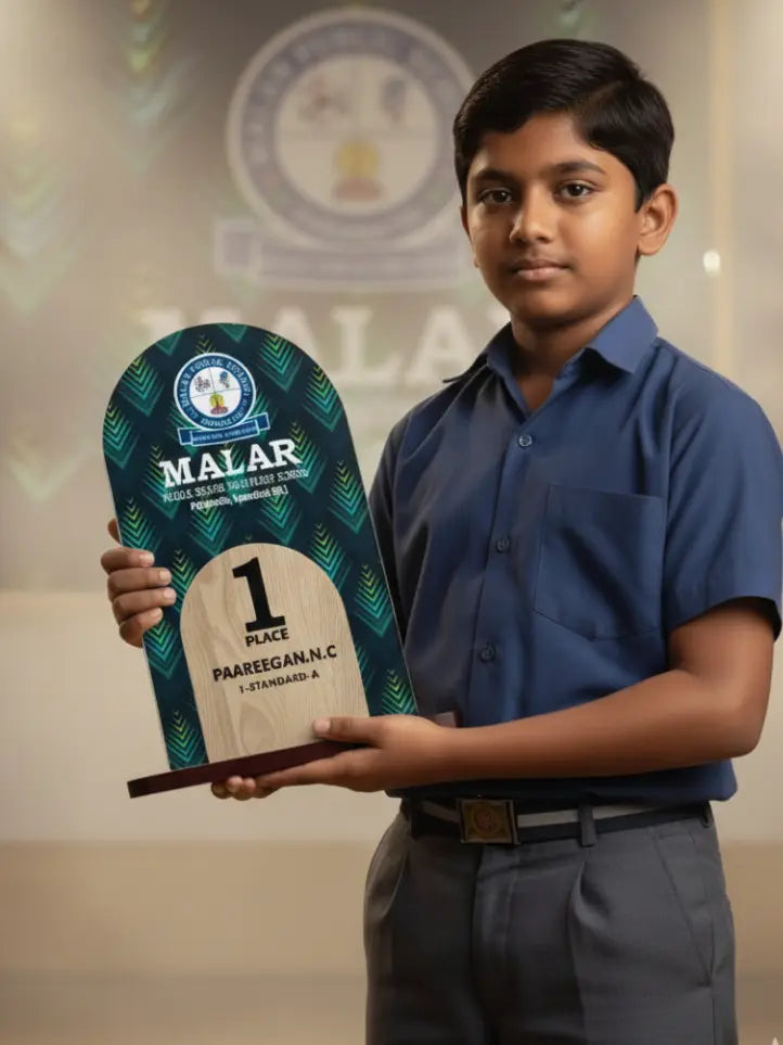 Young boy holding a Malar award in front of a blurred background