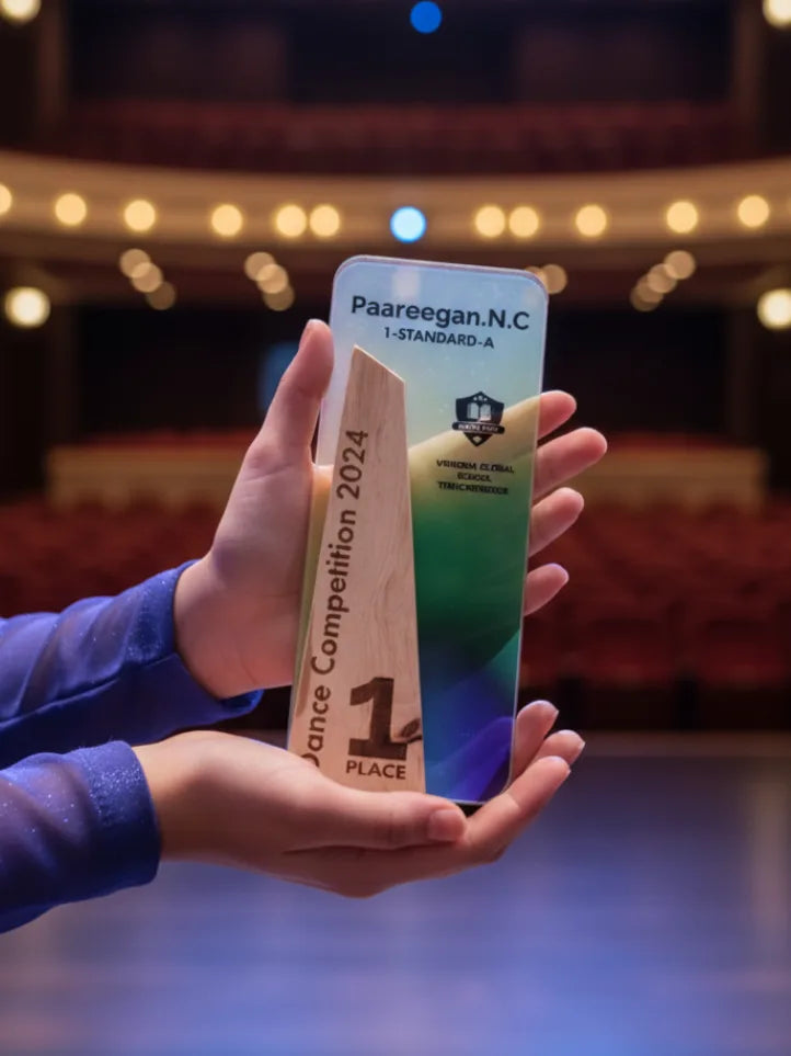 Hand holding a smartphone with a Paareegan.N.C award on a blurred theater stage background