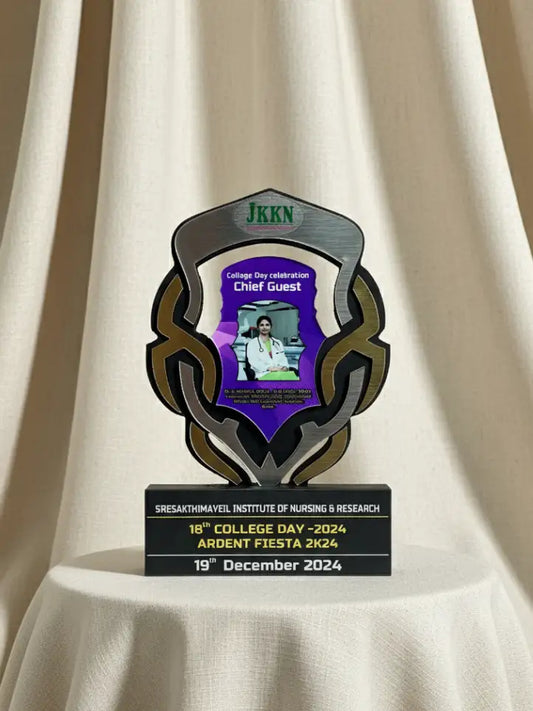 Decorative plaque with text and a video screen on a draped white background