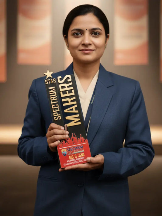 Woman in a blue blazer holding an award with 'Spectrum Makers' on a blurred background