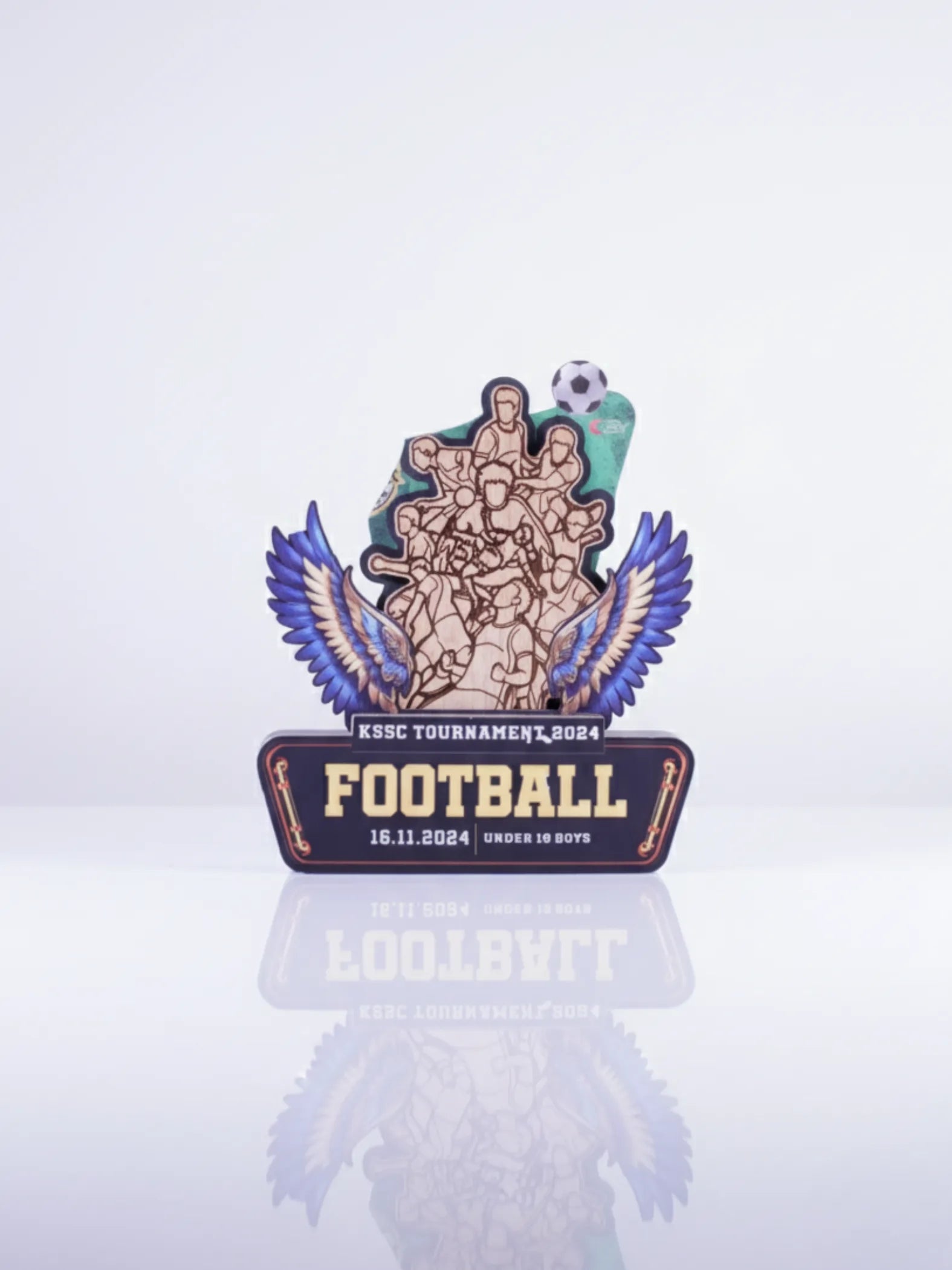 Decorative football trophy with wings on a light gray background