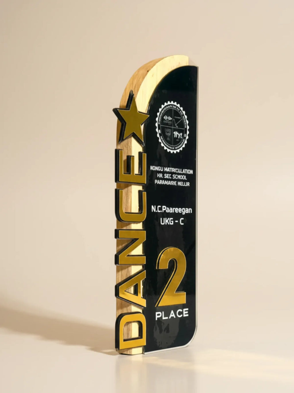 Trophy with gold and black design on a beige background