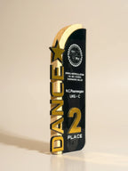 Trophy with gold and black design on a beige background