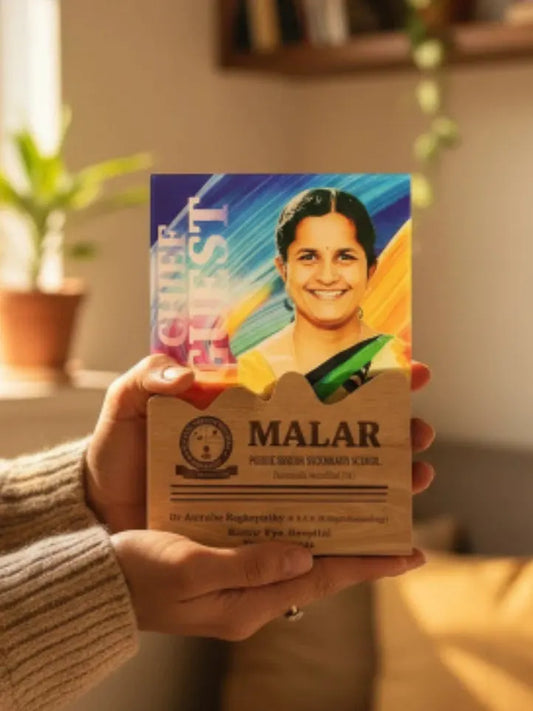 Person holding a box of Malar with a colorful label featuring a smiling woman.