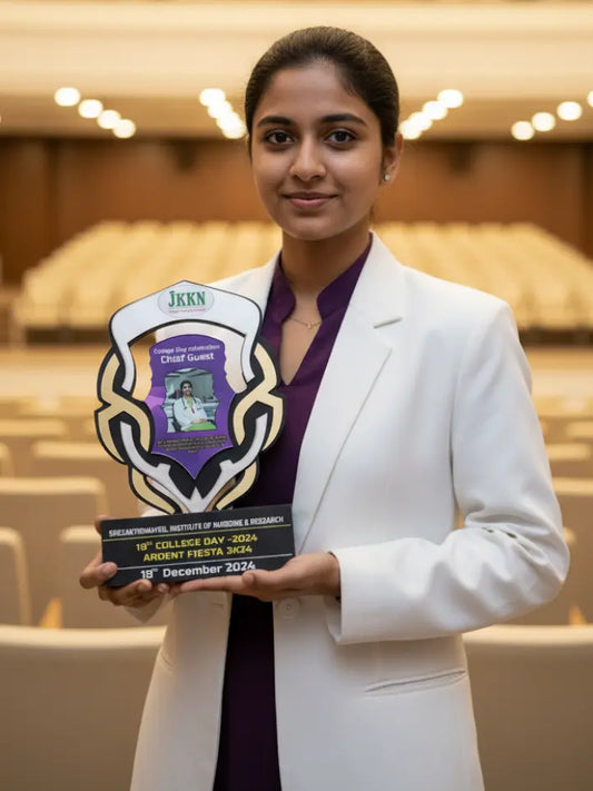Woman in a white blazer holding an award in an indoor setting
