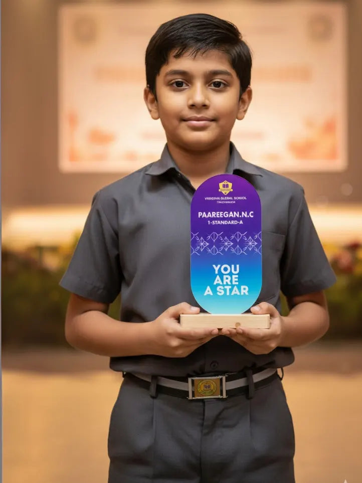 Young boy holding a 'You Are a Star' award with a school logo in an indoor setting.