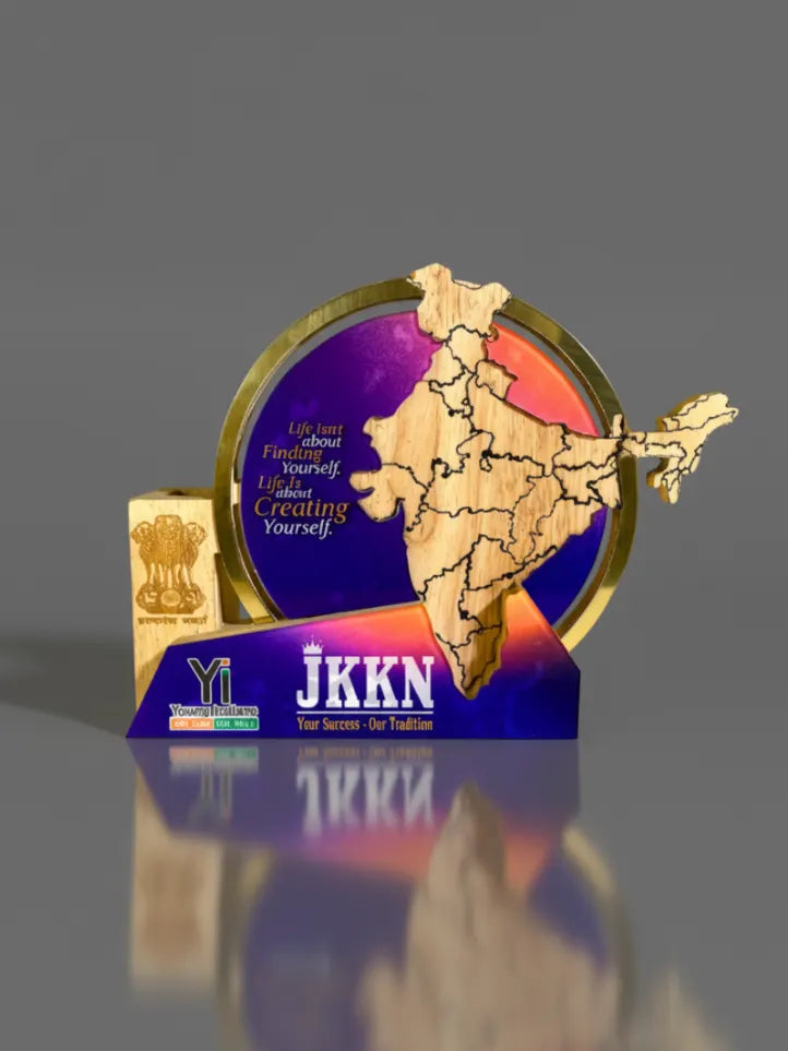 Decorative item with a map design and 'JKKN' branding on a reflective surface.