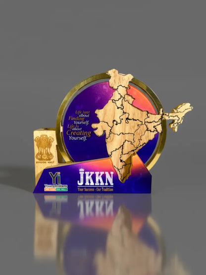 Decorative item with a map design and 'JKKN' branding on a reflective surface.