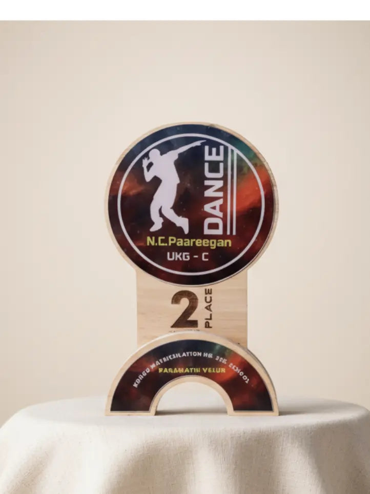 Dance competition trophy with 'N.C. Paareegan' branding on a beige background