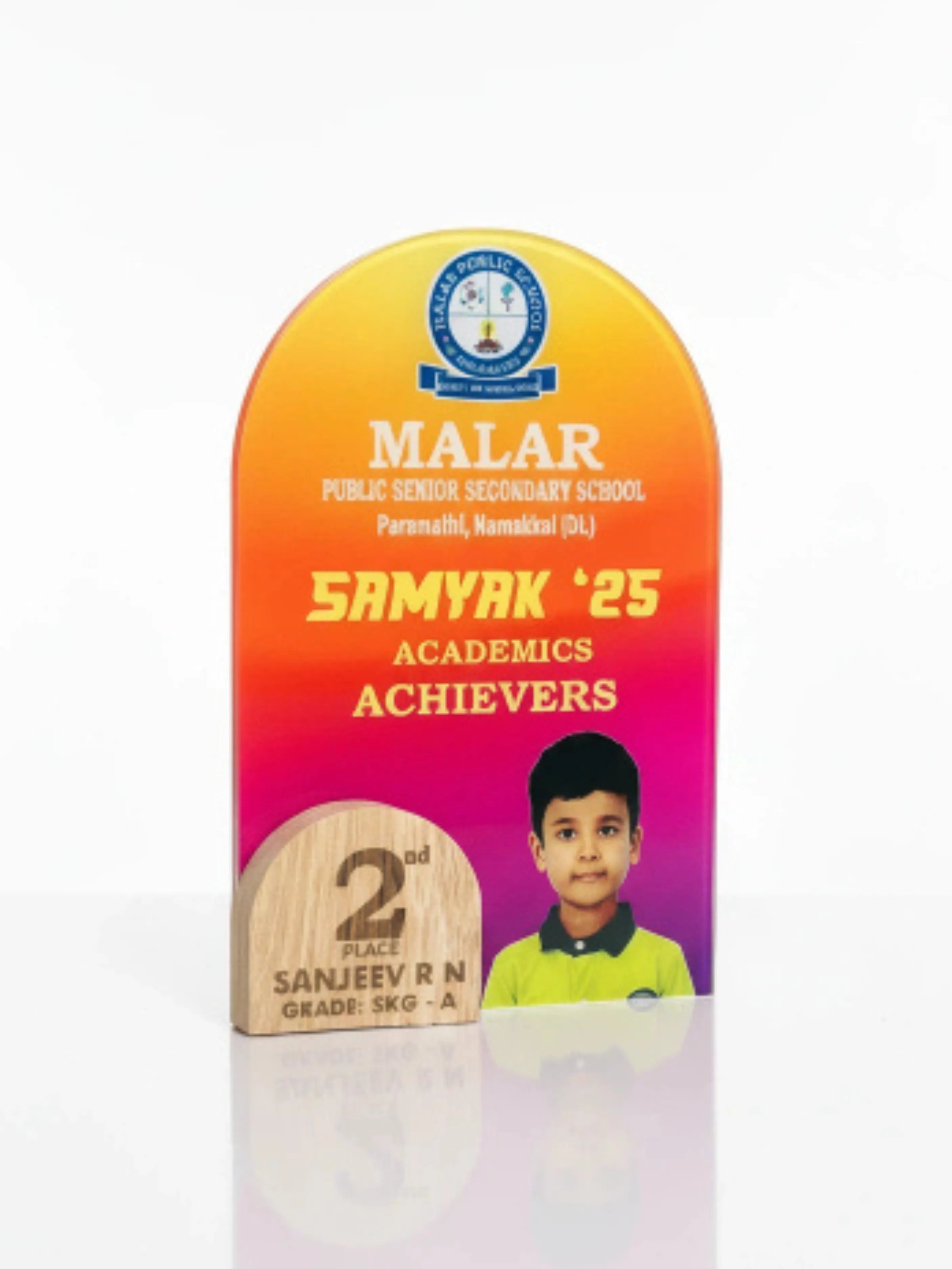 Academic achievement plaque for Malar Public Senior Secondary School with a child's photo and text.