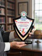 Person holding a kindergarten diploma with colorful design in an office setting