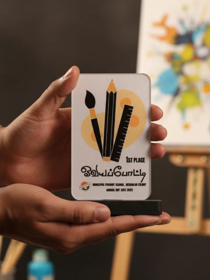 Hand holding a small trophy with artistic design and text