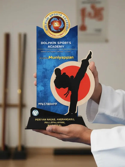 Person holding a promotional card for Dolphin Sports Academy with contact information.
