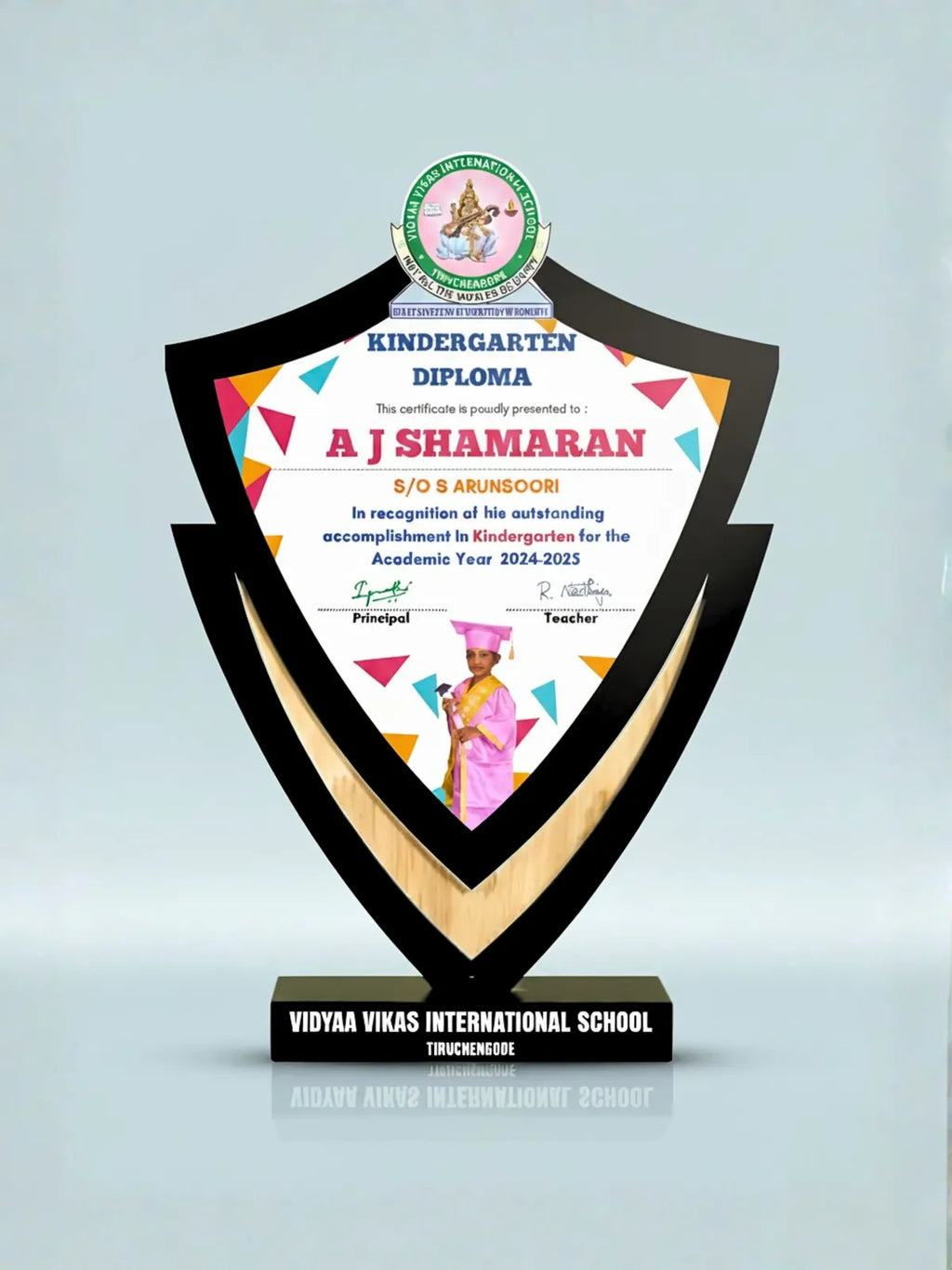 Educational award with a diploma on a black base, featuring logos and text.