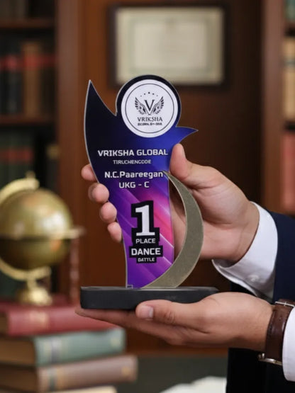 Person holding a Vriksha Global award in a formal setting