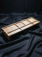 Wooden desk organizer tray with multiple compartments for jewelry and accessories on dark background