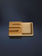 Wooden tray with cutout handles on a dark background