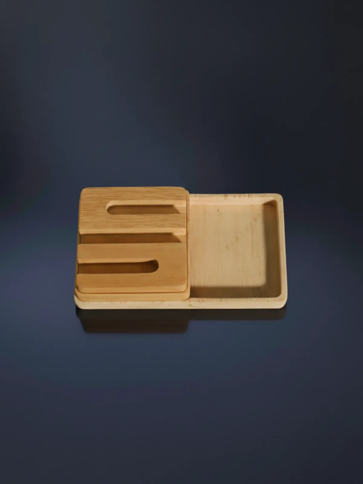 Wooden tray with cutout handles on a dark background