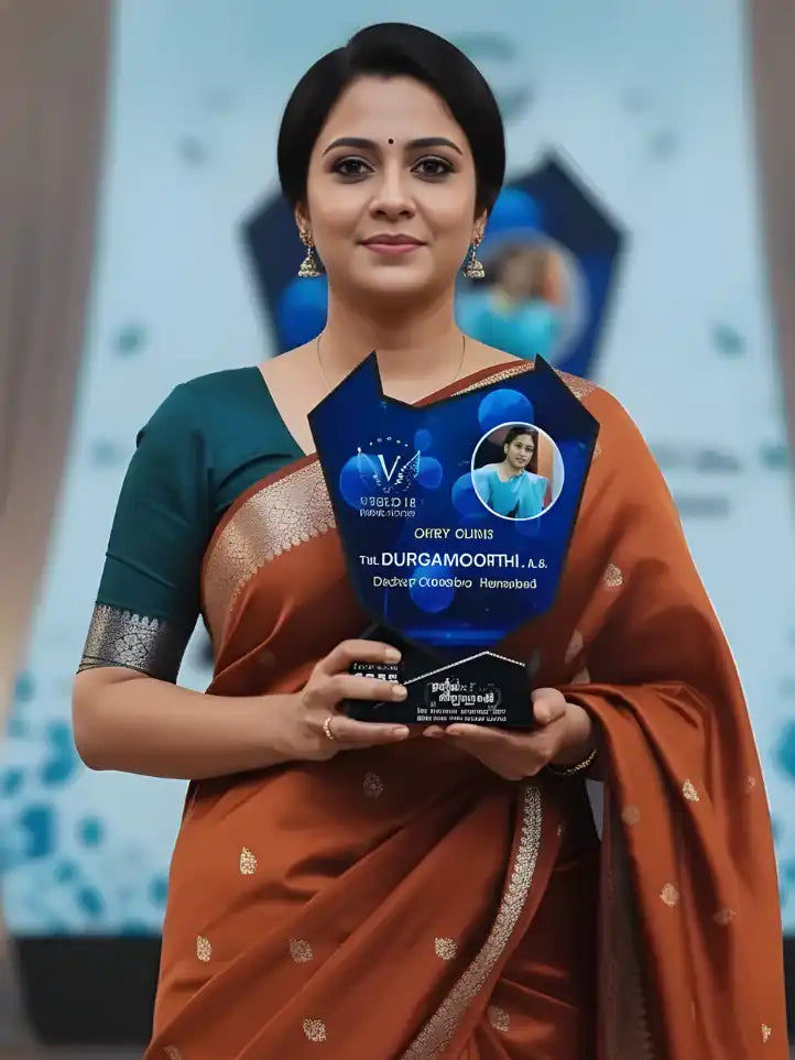 Woman in traditional attire holding an award with a blurred background