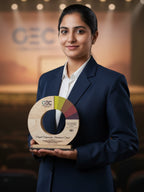 Woman in formal attire holding a GEC award in an indoor setting
