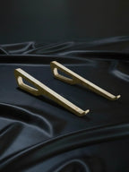Two gold handles on a dark fabric background