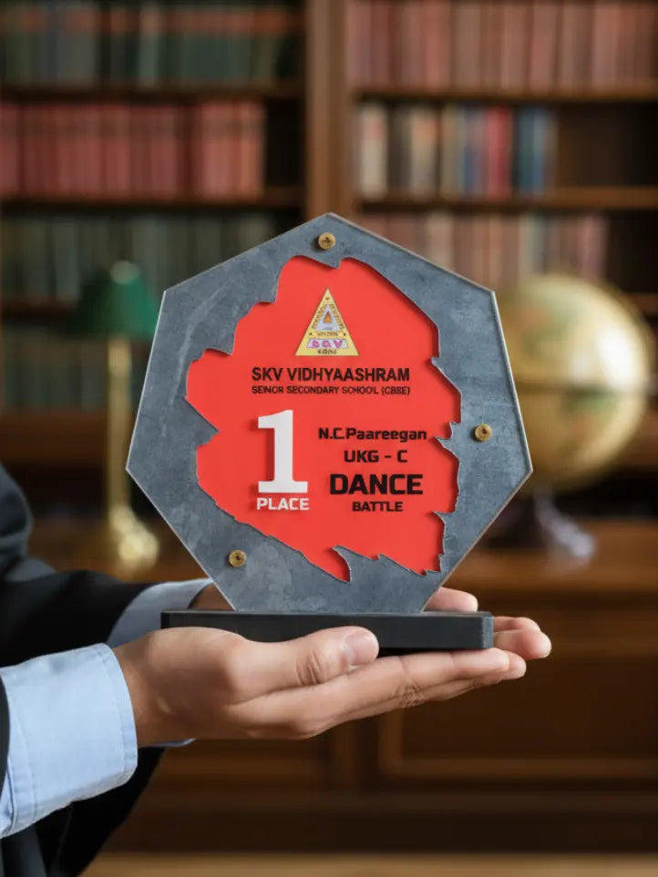 Person holding a dance competition award in a library setting
