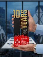 Hand holding a '10 Years' award with red and gold design against a blurred office background