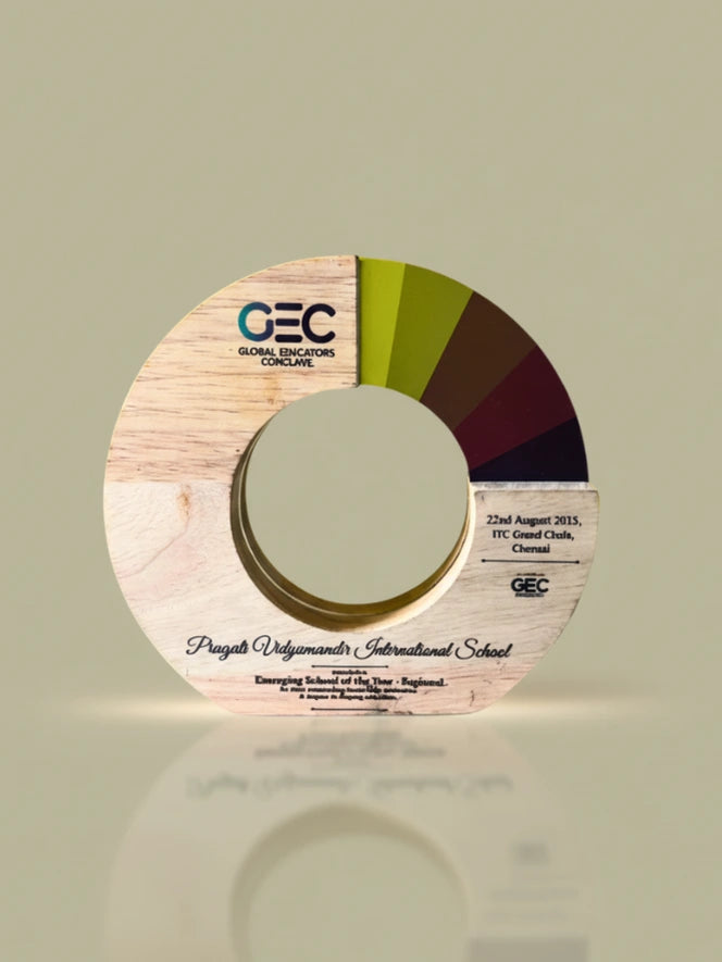 Wooden disc with GEC logo and text on a light green background
