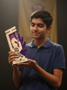 Person holding a chess-themed trophy with a blurred background