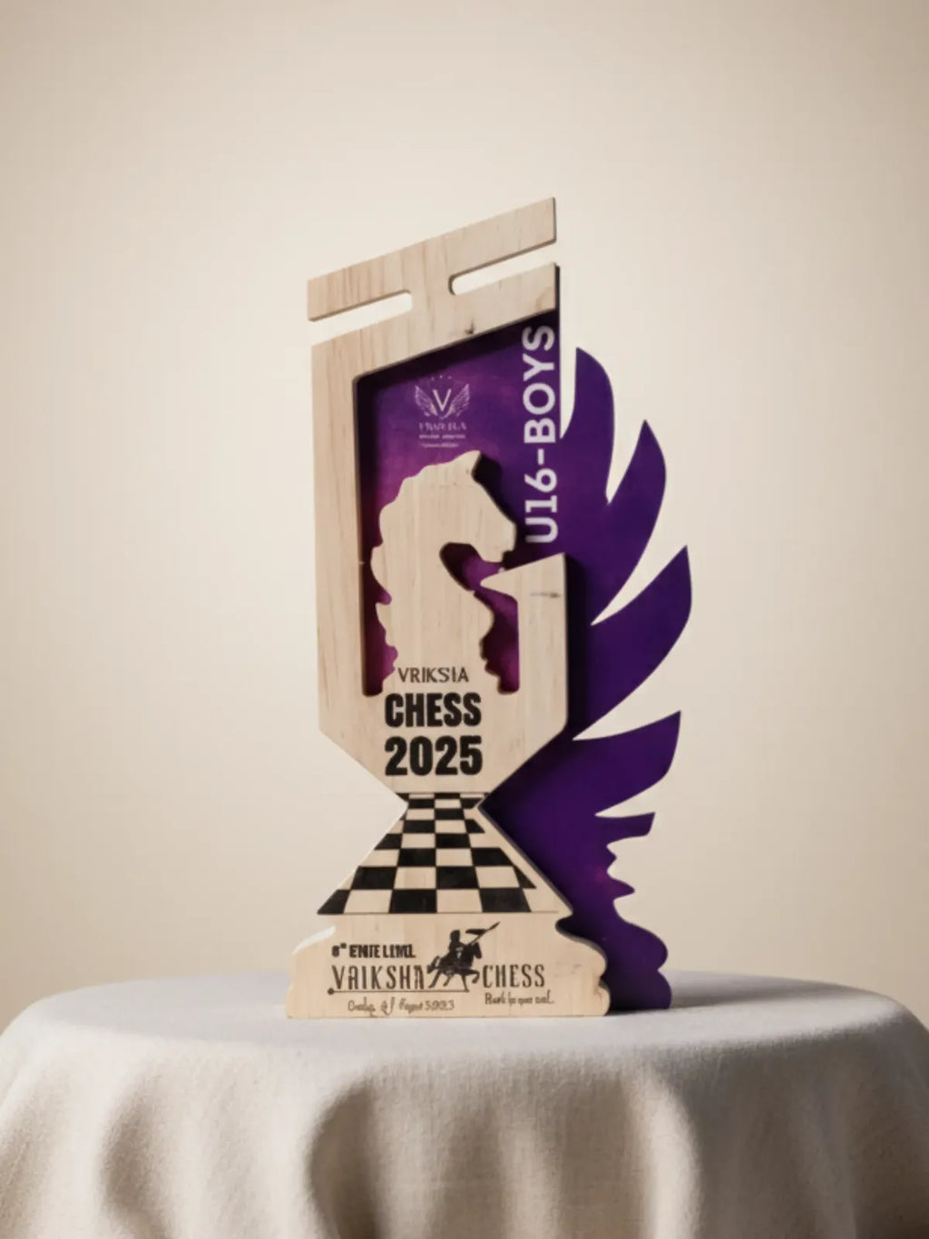 Wooden chess trophy with purple and black design on a beige background