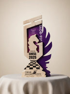 Wooden chess trophy with purple and black design on a beige background